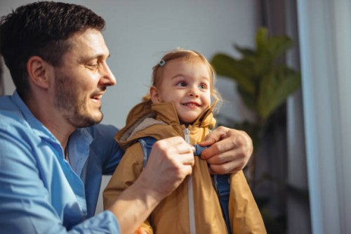 happy dad getting his daughter ready to go outside - junk food stock pictures, royalty-free photos & images