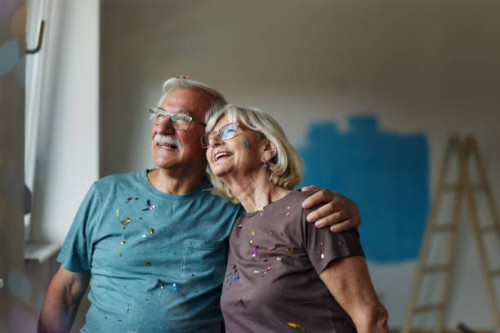 happy embraced senior couple during home renovation process. - home decoration stock pictures, royalty-free photos & images