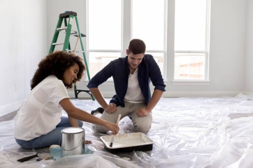 happy expectant couple paint nursery - home decoration stock pictures, royalty-free photos & images