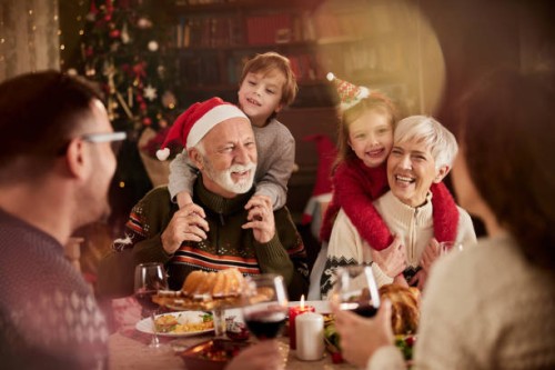 happy extended family enjoying on christmas in dining room. - food stock pictures, royalty-free photos & images
