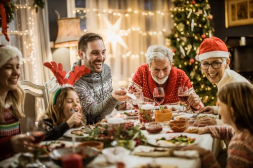 happy extended family having new year's lunch at dining table. - food stock pictures, royalty-free photos & images