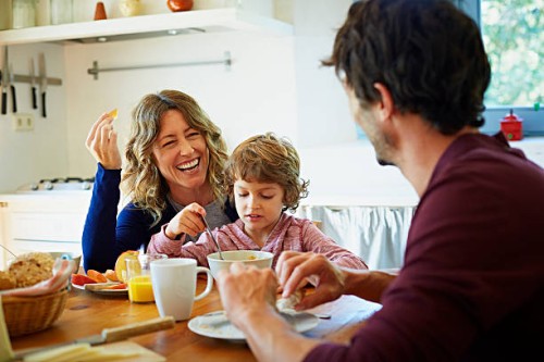 happy family enjoying breakfast at table - food stockfoto's en -beelden