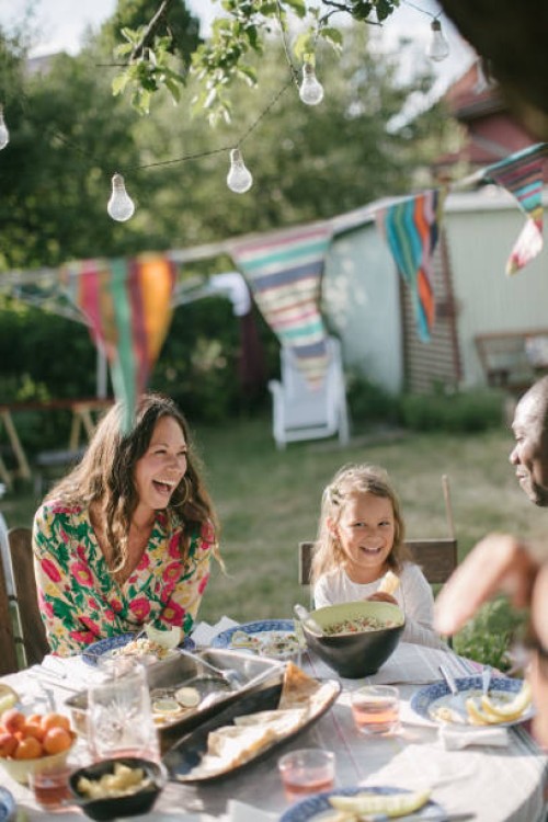 happy family having lunch at table in backyard during garden party - garden decoration photos et images de collection