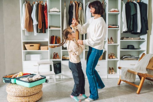 happy family of mom and daughter have fun and dance together at home in a bedroom near the closet - fashion stock pictures, royalty-free photos & images