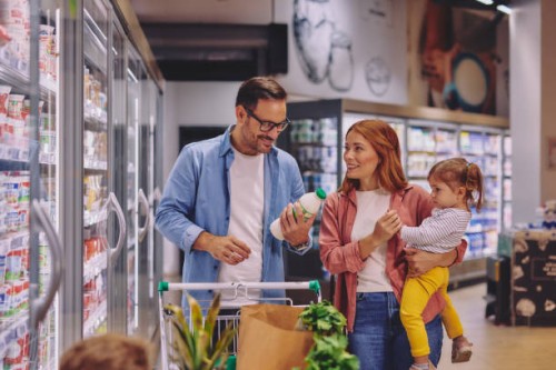 happy family shopping together in a supermarket dairy aisle - food stock pictures, royalty-free photos & images