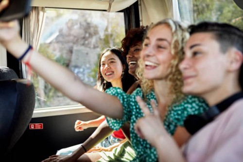happy female friends taking selfie onboard coach bus - travel stock pictures, royalty-free photos & images