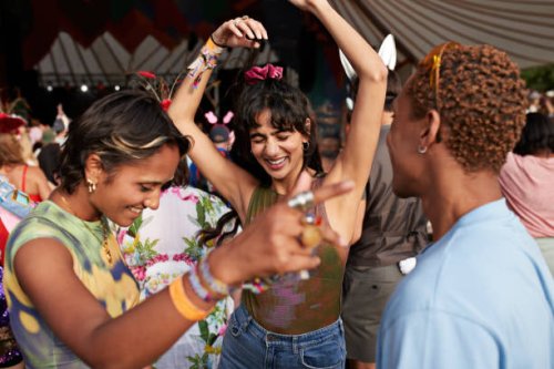 happy festival goers dancing while enjoying at concert - concert stock pictures, royalty-free photos & images