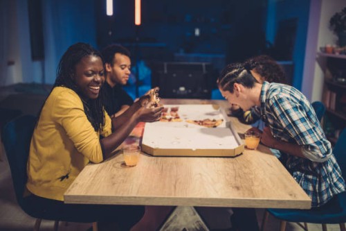 happy friends eating pizza - junk food stock pictures, royalty-free photos & images