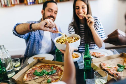 happy friends having french fries and pizza at home - junk food stock pictures, royalty-free photos & images