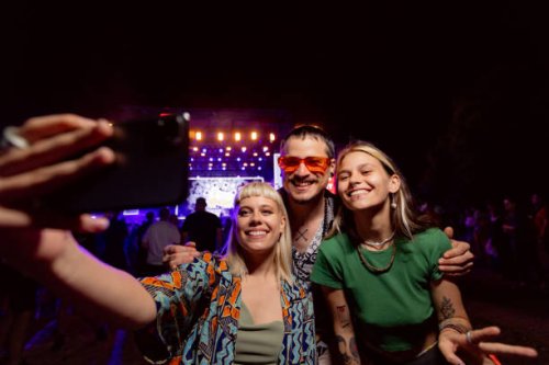 happy friends taking a selfie during a music concert by night. - concert stock pictures, royalty-free photos & images