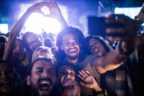 happy friends taking a selfie on music festival by night. - concert stock pictures, royalty-free photos & images