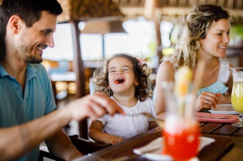 happy girl enjoying with her parents during lunch in a restaurant. - food stock pictures, royalty-free photos & images