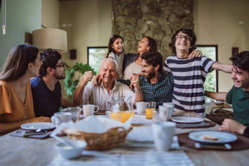 happy grandfather surrounded with his family at breakfast - food stock pictures, royalty-free photos & images