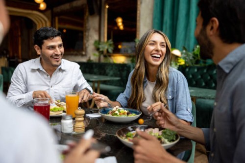 happy group of friends having lunch together at a restaurant - food stock pictures, royalty-free photos & images