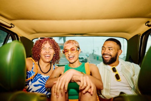 happy group of friends on the back seat of a car, getting away for the weekend. - fashion stock pictures, royalty-free photos & images