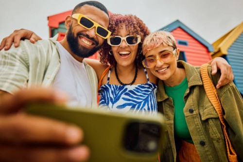 happy group of friends using their smartphone while travelling. - fashion stock pictures, royalty-free photos & images