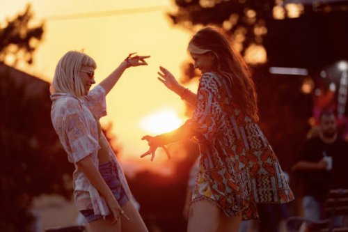 happy hipster women having fun on a music festival at sunset. - concert stock pictures, royalty-free photos & images