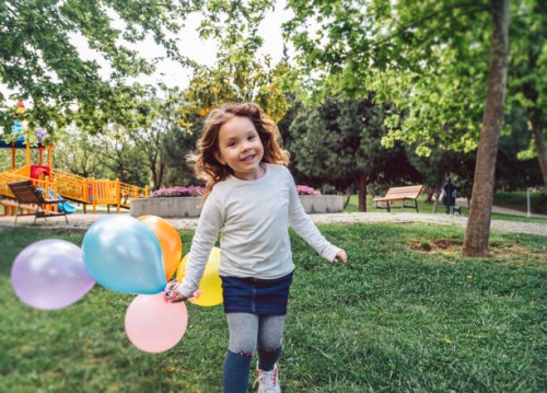 happy kid girl playing with colorful bunch of balloons - garden decoration stock pictures, royalty-free photos & images