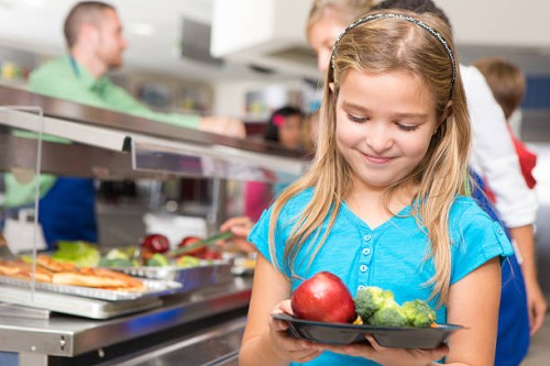happy little girl making healthy choices in school cafeteria - food stock pictures, royalty-free photos & images