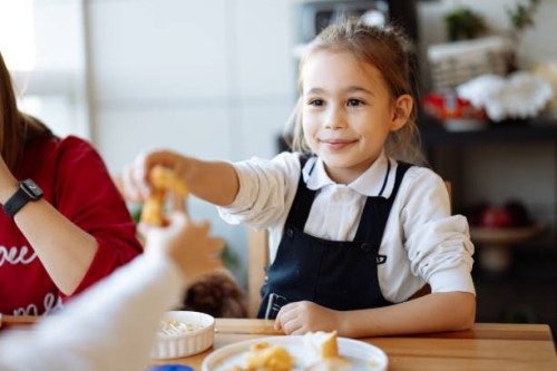 happy little girls enjoying at dinner - junk food stock pictures, royalty-free photos & images