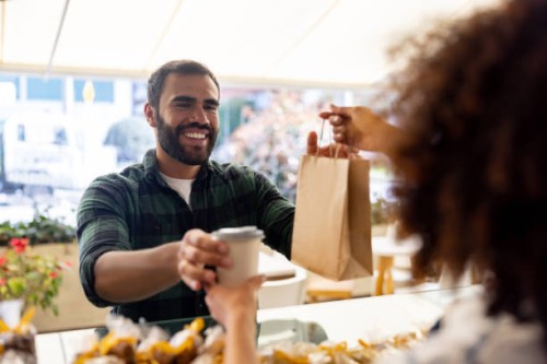 happy man buying take out food at a cafe - food stock pictures, royalty-free photos & images
