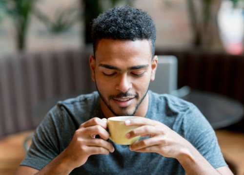 happy man drinking a cup of coffee at a cafe - coffee stock pictures, royalty-free photos & images
