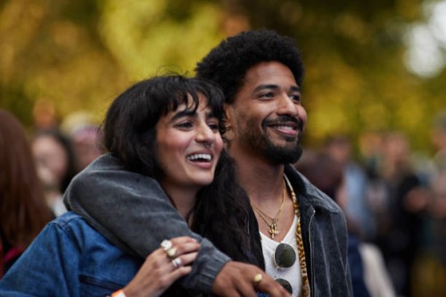 happy man with arm around girlfriend looking away - concert stock pictures, royalty-free photos & images