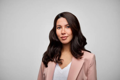 happy mixed race female brunette ceo wearing pink blazer. - hairstyle photos et images de collection