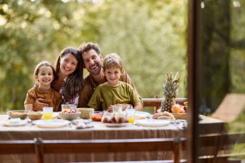 happy parents and their kids having picnic in nature. - garden decoration photos et images de collection
