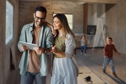 happy parents using digital tablet in their new home. - home decoration stock pictures, royalty-free photos & images