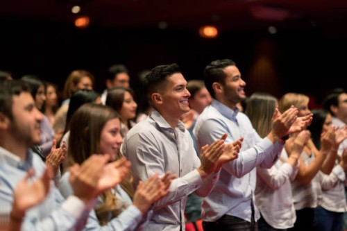 happy people at a concert in a theater doing a standing ovation and applauding - concert stock pictures, royalty-free photos & images
