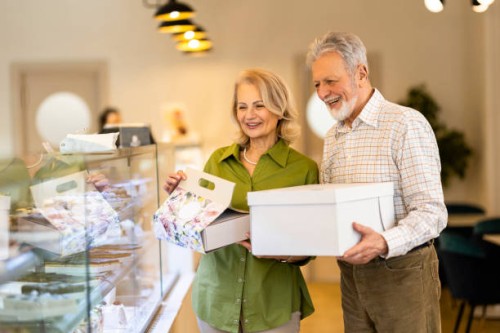 happy senior couple buying cakes - junk food stock pictures, royalty-free photos & images