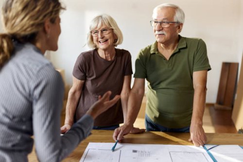 happy senior couple talking about blueprints with their architect. - home decoration stock pictures, royalty-free photos & images