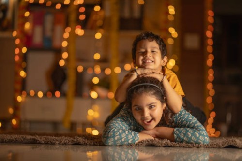 happy siblings lying on carpet at home - home decoration stock pictures, royalty-free photos & images