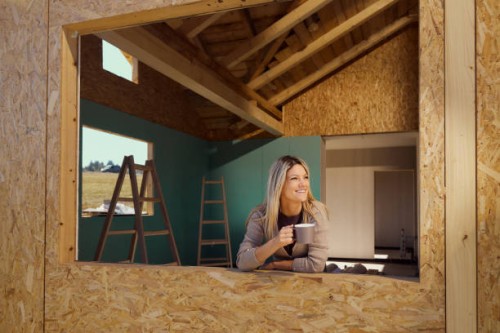 happy woman drinking coffee on a window frame of a built structure. - home decoration stock pictures, royalty-free photos & images