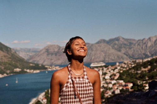 happy woman enjoying sunlight on face during vacation - travel stock pictures, royalty-free photos & images