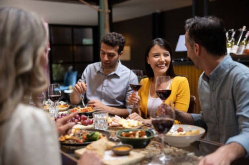 happy woman having dinner with a group of friends - food stock pictures, royalty-free photos & images