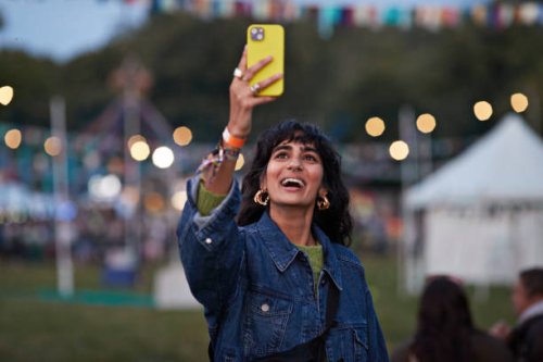 happy woman photographing through mobile phone - concert stock pictures, royalty-free photos & images
