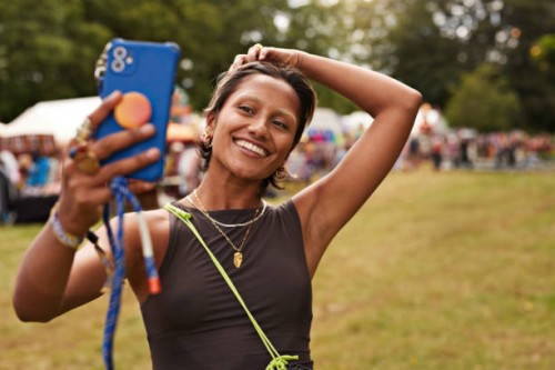 happy woman taking selfie through smart phone - concert stock pictures, royalty-free photos & images