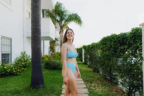 happy woman walking in tropical garden among palm trees - garden decoration stock pictures, royalty-free photos & images