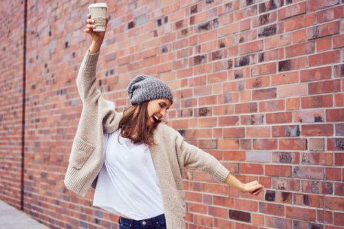 happy woman with coffee to go singing and dancing on the street - junk food stock pictures, royalty-free photos & images