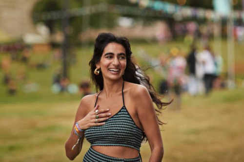 happy woman with hand on chest walking at park - concert stock pictures, royalty-free photos & images