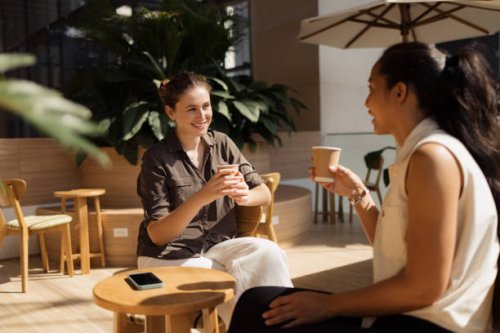 happy women talking in coffee shop. - coffee stock pictures, royalty-free photos & images