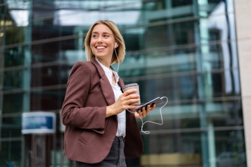 happy young businesswoman in the city on the go - junk food stock pictures, royalty-free photos & images