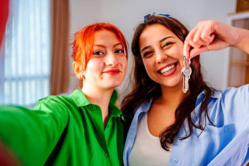 happy young caucasian couple young women holding house apartment keys, taking selfie - home decoration stock pictures, royalty-free photos & images