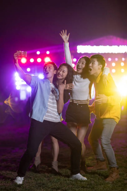 happy young chinese friends taking selfie at music festival - concert stock pictures, royalty-free photos & images