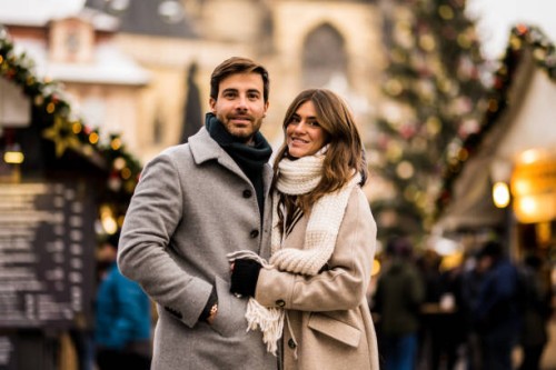 happy young couple enjoying a christmas day together in the city. - fashion stock pictures, royalty-free photos & images