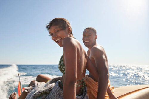 happy young couple sitting on boat deck - travel photos et images de collection