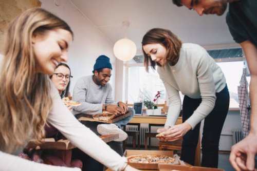 happy young friends eating pizza in college dorm room - junk food stock pictures, royalty-free photos & images