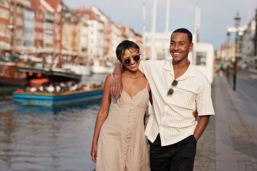 happy young man and woman walking on pier - fashion stock pictures, royalty-free photos & images